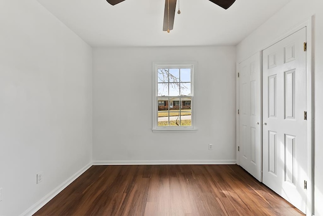 unfurnished bedroom with dark wood-type flooring and ceiling fan