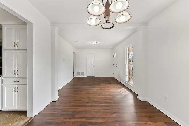 interior space featuring dark hardwood / wood-style flooring and a notable chandelier