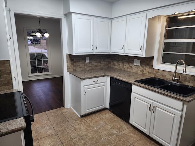 kitchen with dishwasher, sink, an inviting chandelier, decorative light fixtures, and white cabinets