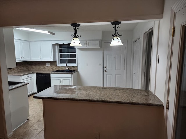 kitchen with white cabinetry, sink, hanging light fixtures, black dishwasher, and backsplash