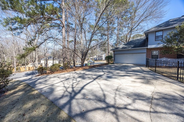 7015 Widgeon Dr, Midland, GA 31820 - view of side of property featuring driveway, brick siding, and an attached garage