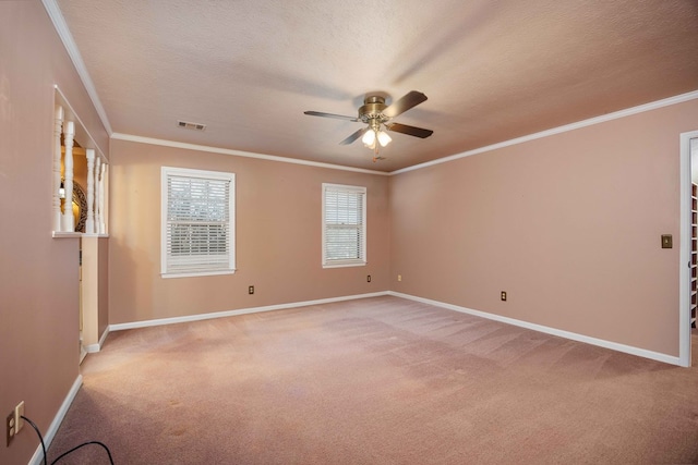 spare room featuring visible vents, light colored carpet, and ornamental molding