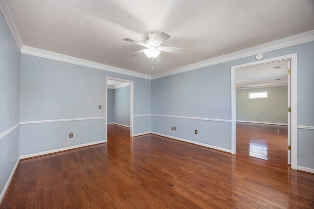 spare room with baseboards, crown molding, a ceiling fan, and wood finished floors