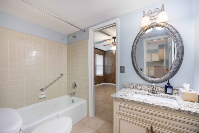 bathroom featuring toilet, ceiling fan, tile patterned floors, tub / shower combination, and vanity