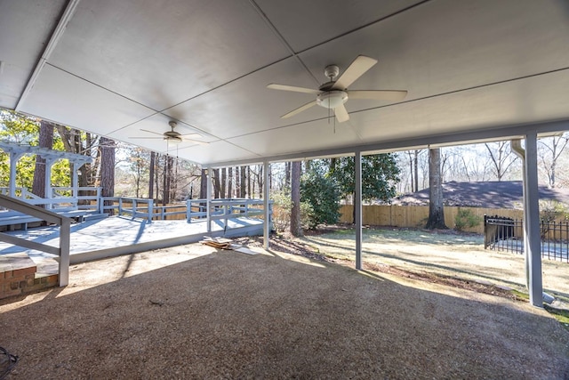 unfurnished sunroom with a ceiling fan