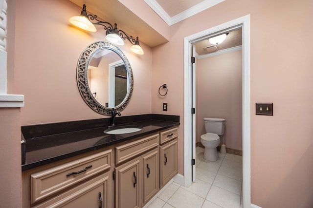 bathroom with tile patterned flooring, toilet, vanity, baseboards, and ornamental molding