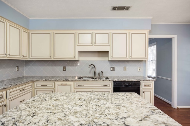 7015 Widgeon Dr, Midland, GA 31820 - kitchen with cream cabinets, black dishwasher, a sink, ornamental molding, and light stone counters