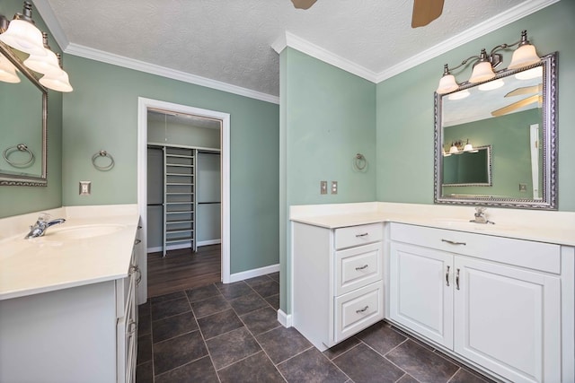 7015 Widgeon Dr, Midland, GA 31820 - bathroom with two vanities, a ceiling fan, a spacious closet, baseboards, and a textured ceiling