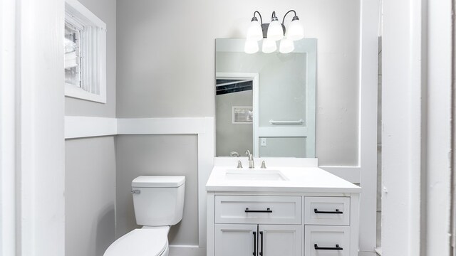 bathroom featuring vanity and toilet