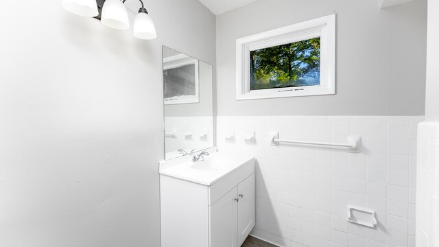 bathroom featuring vanity and tile walls