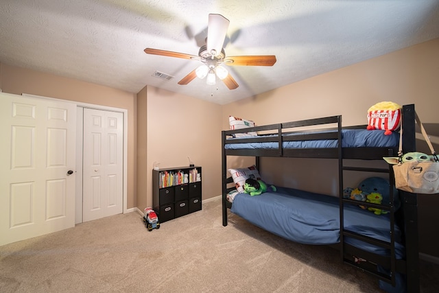 6801 Buckeye Way, Columbus, GA 31904 - bedroom featuring carpet, a ceiling fan, a closet, and a textured ceiling