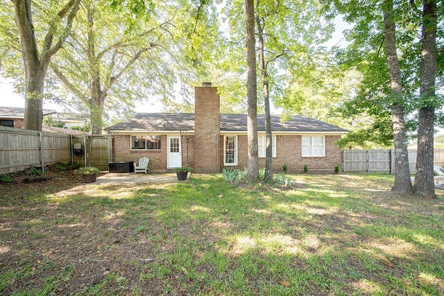 6801 Buckeye Way, Columbus, GA 31904 - back of house featuring a chimney, a fenced backyard, brick siding, and a gate