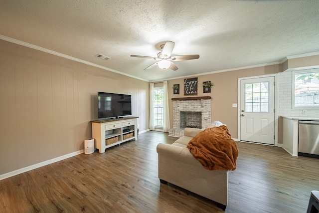 6801 Buckeye Way, Columbus, GA 31904 - living area with wood finished floors, ceiling fan, healthy amount of natural light, a textured ceiling, and a brick fireplace