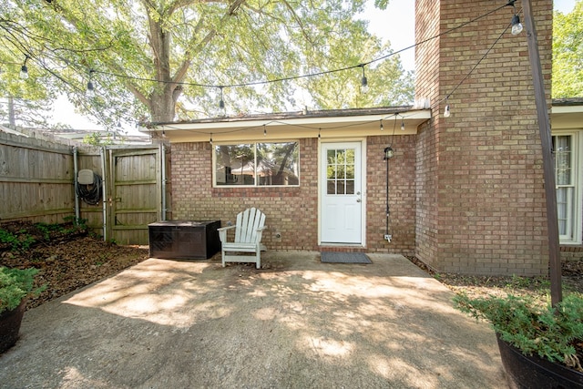 6801 Buckeye Way, Columbus, GA 31904 - view of exterior entry with a patio area, brick siding, and a gate