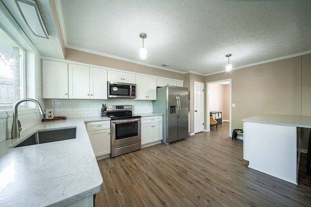6801 Buckeye Way, Columbus, GA 31904 - kitchen featuring stainless steel appliances, a textured ceiling, dark wood-style flooring, tasteful backsplash, and ornamental molding