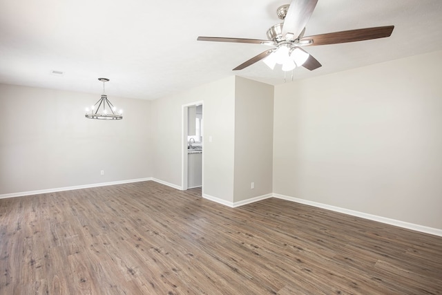 8085 Ga Highway 0219, Hamilton, GA 31811 - spare room with wood finished floors, a chandelier, baseboards, and a ceiling fan