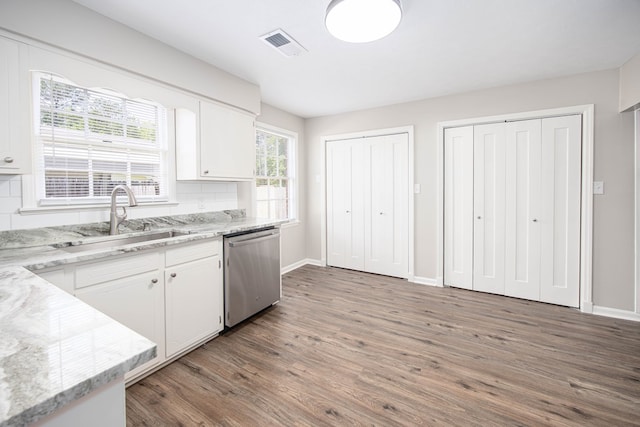 8085 Ga Highway 0219, Hamilton, GA 31811 - kitchen with stainless steel dishwasher, a sink, wood finished floors, and white cabinets