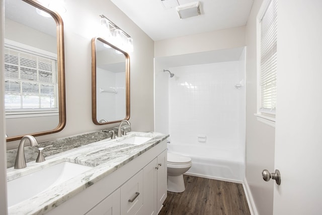 8085 Ga Highway 0219, Hamilton, GA 31811 - full bathroom featuring wood finished floors, toilet, double vanity, and plenty of natural light