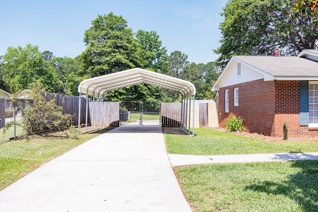 8085 Ga Highway 0219, Hamilton, GA 31811 - view of parking featuring concrete driveway, a carport, and a gate