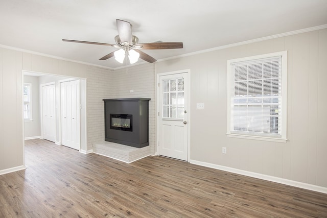 8085 Ga Highway 0219, Hamilton, GA 31811 - unfurnished living room with ornamental molding, wood finished floors, ceiling fan, a glass covered fireplace, and baseboards