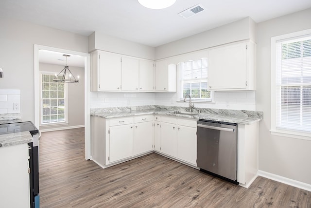 8085 Ga Highway 0219, Hamilton, GA 31811 - kitchen with dishwasher, a sink, range with electric cooktop, wood finished floors, and white cabinetry
