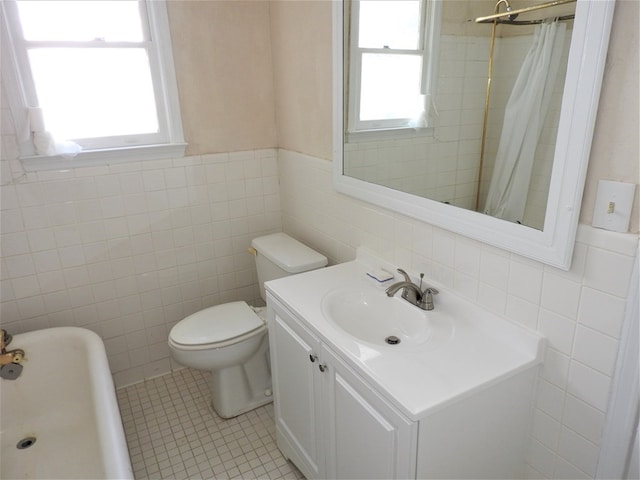 1346 22nd St, Columbus, GA 31901 - bathroom featuring tile walls, tile patterned flooring, a wainscoted wall, a shower with shower curtain, and vanity