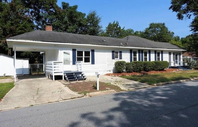 1346 22nd St, Columbus, GA 31901 - ranch-style house featuring a chimney, driveway, an attached carport, and covered porch