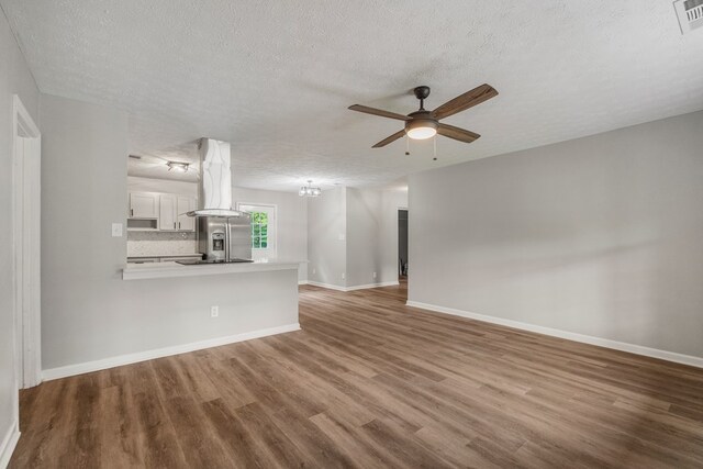 2906 Kent Dr, Phenix City, AL 36870 - unfurnished living room with a textured ceiling, wood finished floors, and a ceiling fan