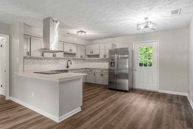 2906 Kent Dr, Phenix City, AL 36870 - kitchen with stainless steel fridge, island range hood, dark wood-style floors, a peninsula, and tasteful backsplash