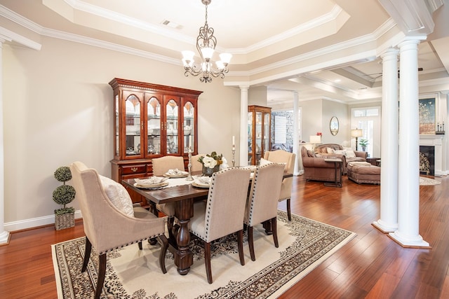 1438 Grove Park Dr Unit 8B, Columbus, GA 31904 - dining area with ornate columns, a tray ceiling, wood finished floors, and crown molding