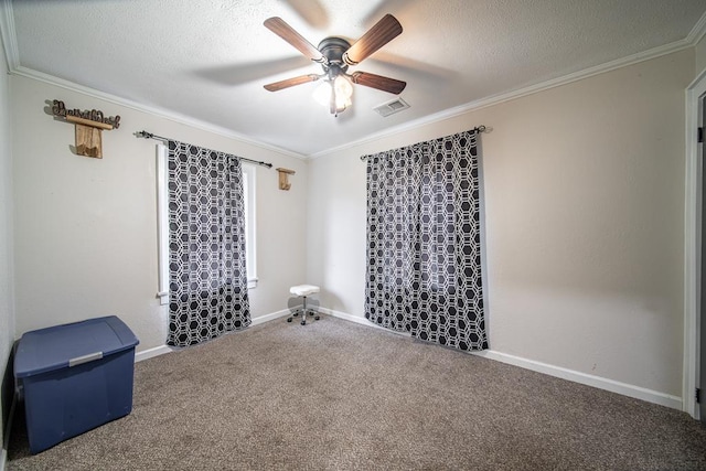 unfurnished room with carpet, a textured ceiling, ceiling fan, and crown molding