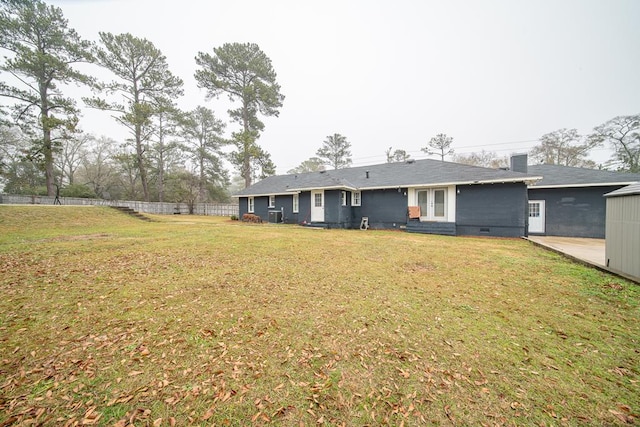 rear view of property featuring a yard and french doors