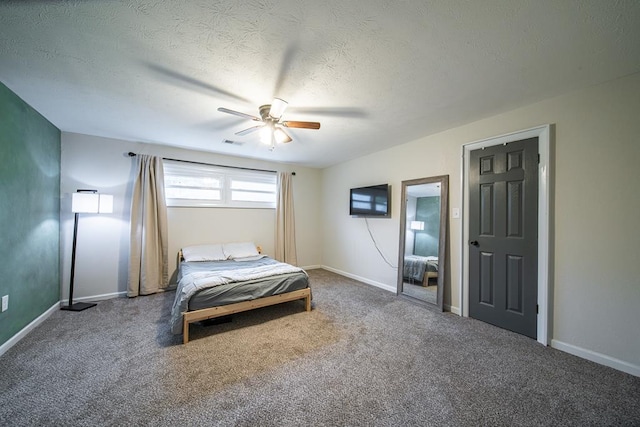 carpeted bedroom with ceiling fan and a textured ceiling