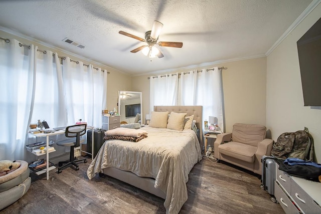 bedroom featuring ceiling fan, dark hardwood / wood-style flooring, a textured ceiling, and crown molding