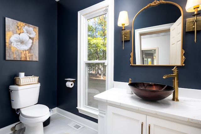 bathroom featuring vanity and toilet