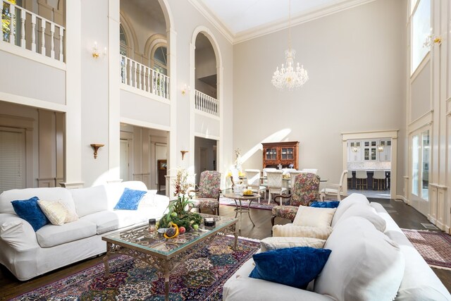 5410 River Oak Way, Phenix City, AL 36867 - living room with a high ceiling, a chandelier, ornamental molding, wood finished floors, and baseboards