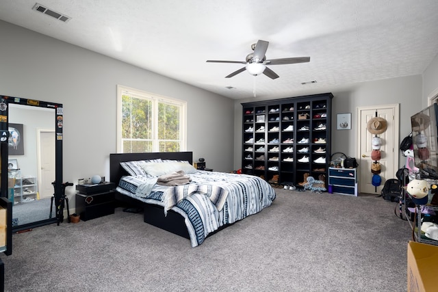 bedroom with carpet flooring, ceiling fan, and a textured ceiling