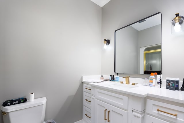 bathroom featuring vanity and toilet