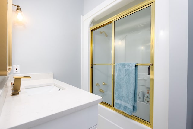 bathroom featuring vanity and combined bath / shower with glass door