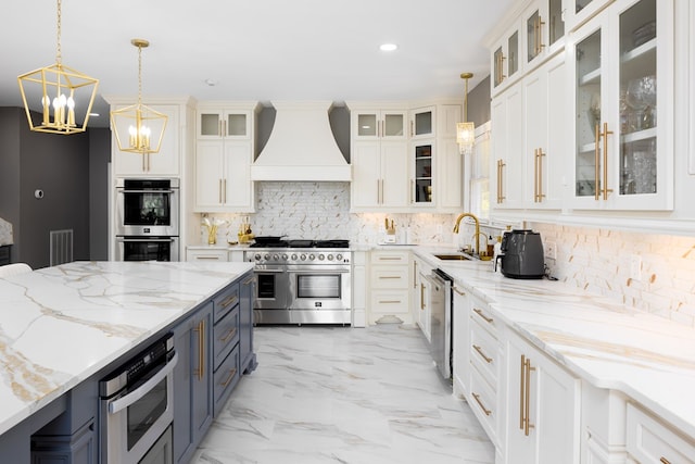 5410 River Oak Way, Phenix City, AL 36867 - kitchen with appliances with stainless steel finishes, premium range hood, a sink, a chandelier, and decorative light fixtures