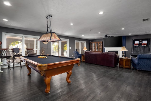 rec room with ceiling fan, a textured ceiling, pool table, a baseboard radiator, and dark hardwood / wood-style flooring