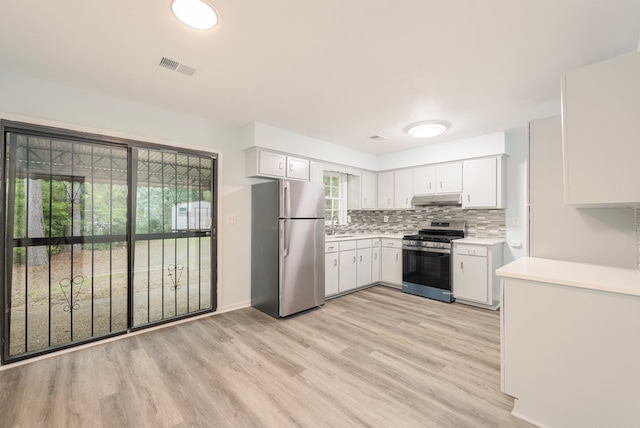 5011 Edo Ct, Columbus, GA 31907 - kitchen with stainless steel appliances, light countertops, backsplash, under cabinet range hood, and light wood-style floors