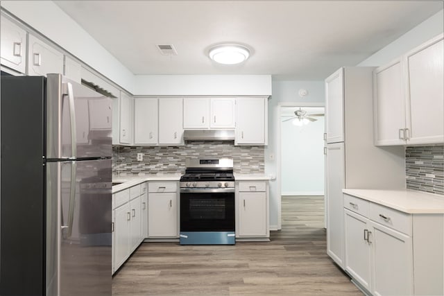 5011 Edo Ct, Columbus, GA 31907 - kitchen featuring appliances with stainless steel finishes, under cabinet range hood, light countertops, backsplash, and ceiling fan