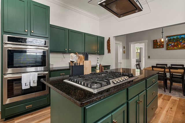 1917 Dimon St, Columbus, GA 31906 - kitchen with stainless steel appliances, green cabinets, light wood-style floors, ornamental molding, and wainscoting
