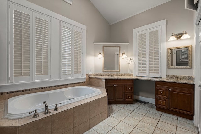 1917 Dimon St, Columbus, GA 31906 - bathroom with vaulted ceiling, vanity, a garden tub, tile patterned floors, and crown molding