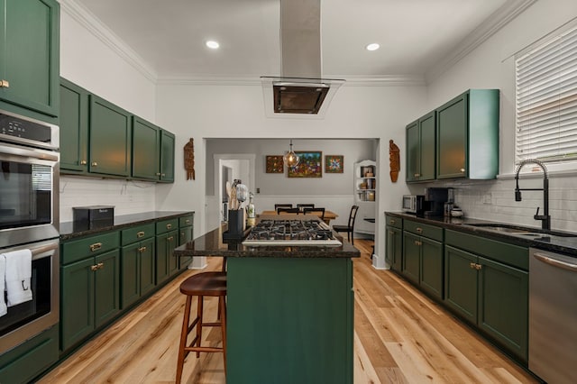 1917 Dimon St, Columbus, GA 31906 - kitchen featuring green cabinetry, stainless steel appliances, a center island, ornamental molding, and backsplash
