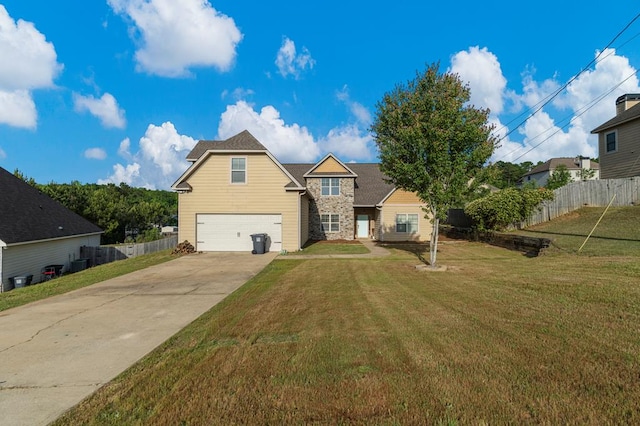 28 Red Maple Dr, Phenix City, AL 36869 - view of front of home featuring fence, stone siding, a front yard, concrete driveway, and an attached garage
