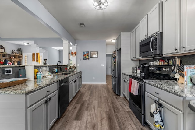 28 Red Maple Dr, Phenix City, AL 36869 - kitchen with a sink, dark wood-style flooring, black appliances, and light stone countertops