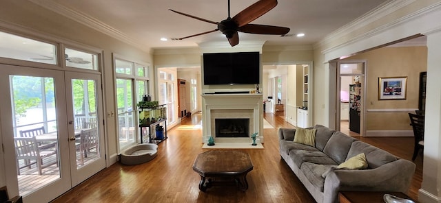 living room featuring french doors, a ceiling fan, and wood finished floors
