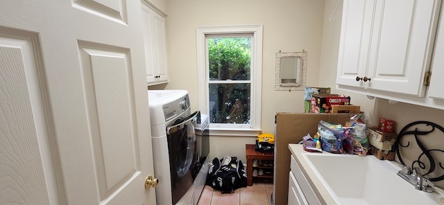 washroom featuring a sink, cabinet space, and light tile patterned floors